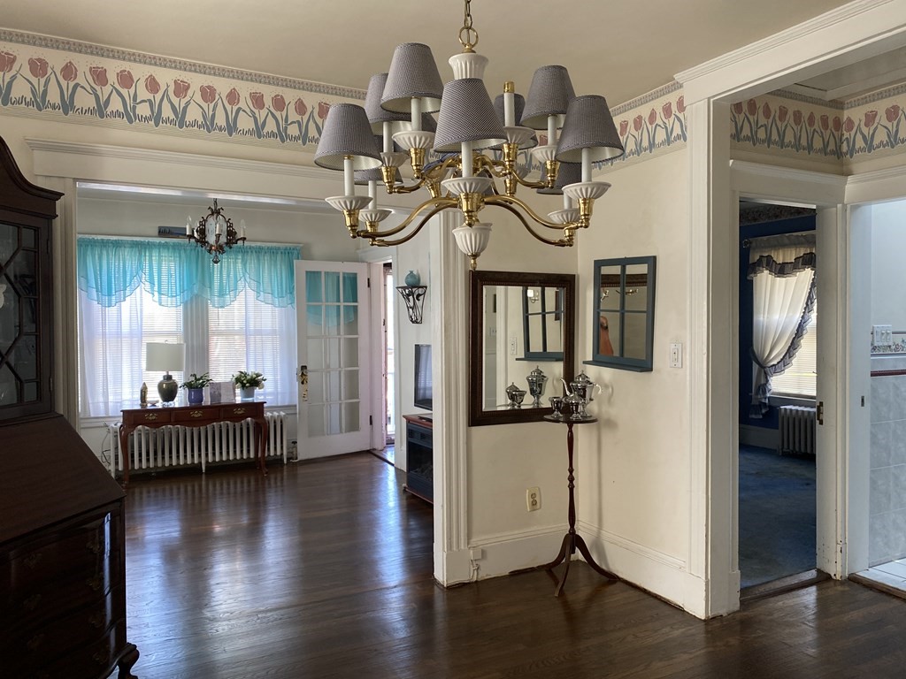 21 Trevalley Road Revere, MA 02151 - Photo 8 of 9 a view of a livingroom with furniture wooden floor windows and a chandelier