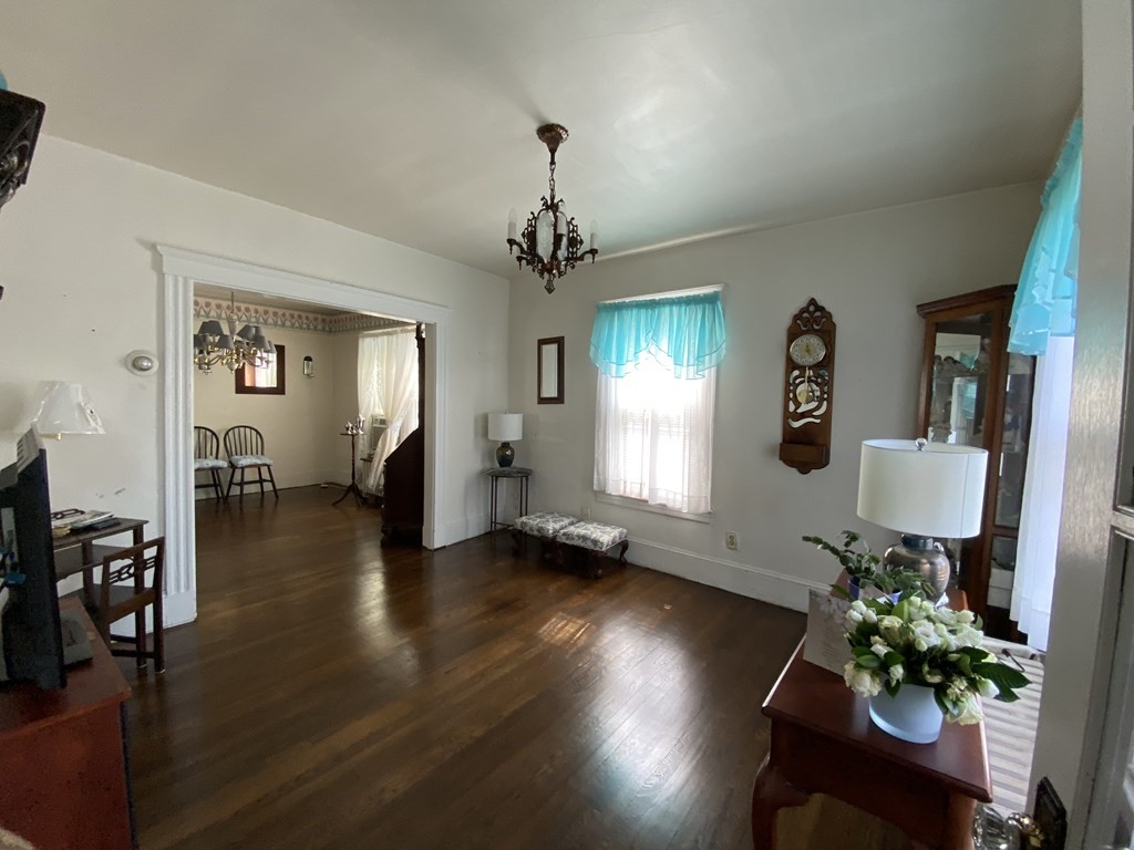 21 Trevalley Road Revere, MA 02151 - Photo 9 of 9 a view of a livingroom with furniture a chandelier and wooden floor