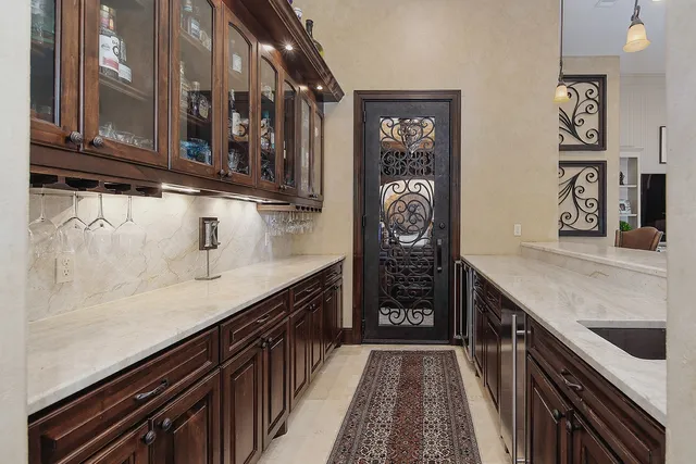 a kitchen with stainless steel appliances a sink and cabinets