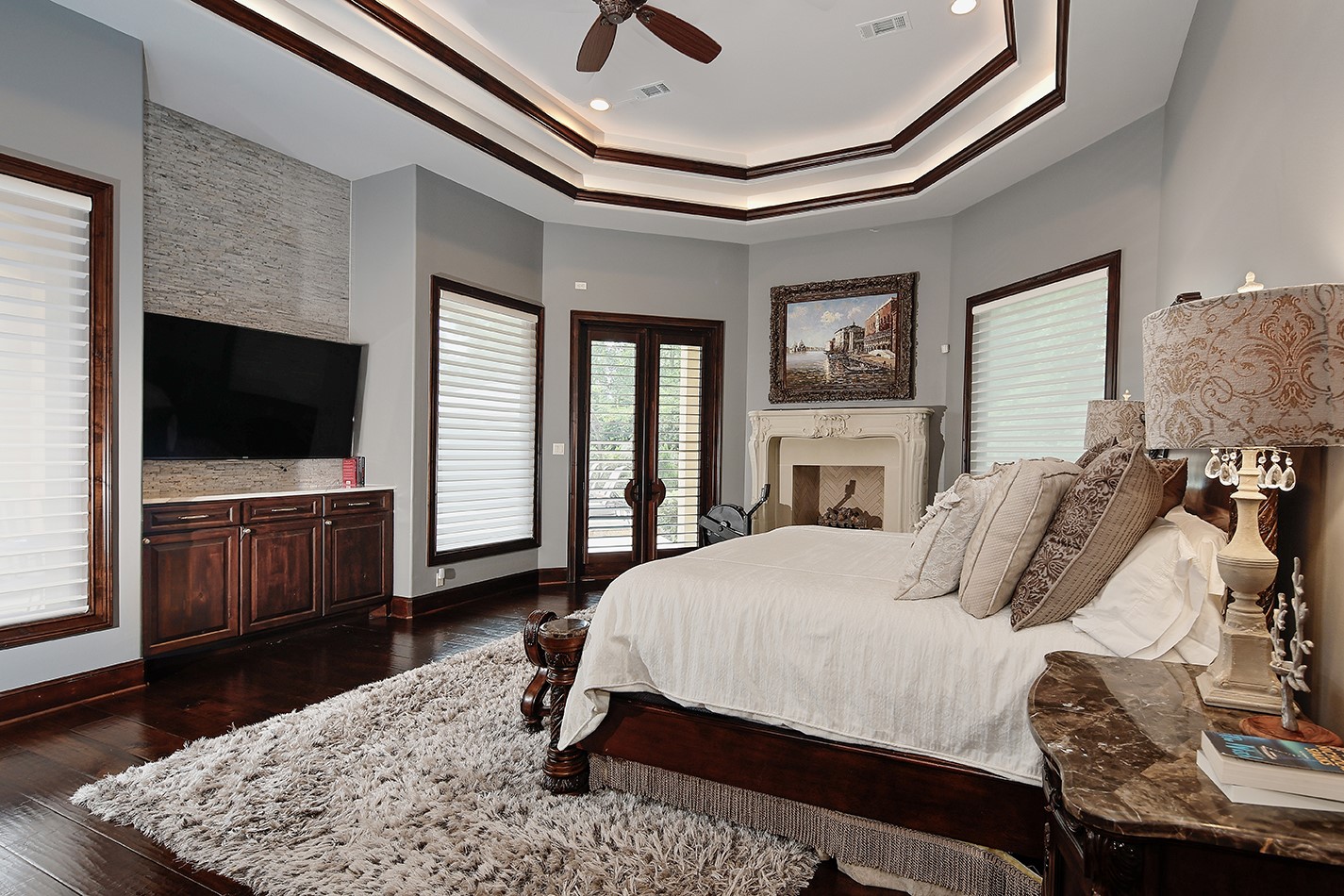 2 Lace Point The Woodlands, TX 77382 - Photo 17 of 48 a bedroom with a bed and a flat screen tv