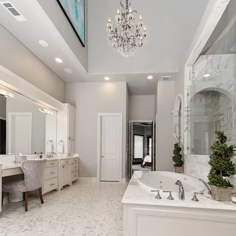 a large white kitchen with a large tub and sink