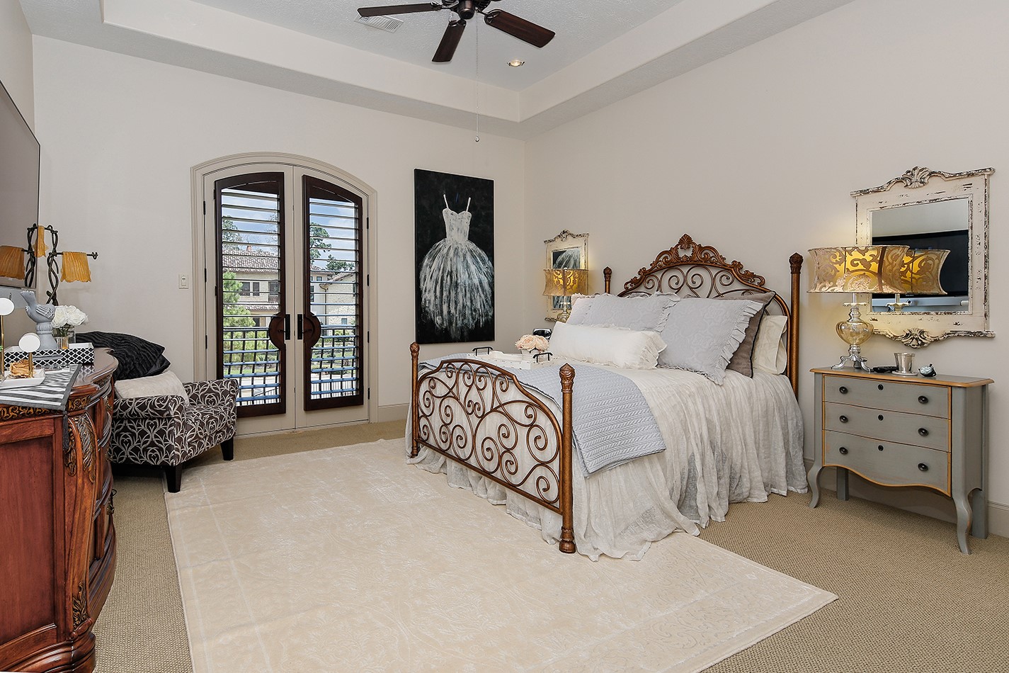 2 Lace Point The Woodlands, TX 77382 - Photo 23 of 48 a bedroom with a bed and a television