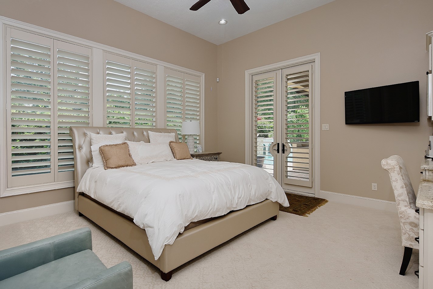 2 Lace Point The Woodlands, TX 77382 - Photo 31 of 48 a spacious bedroom with a bed and a flat screen television