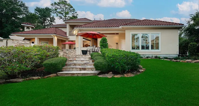 a front view of a house with a garden