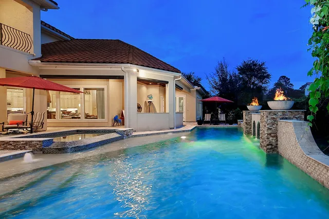 a view of a house with backyard porch and sitting area