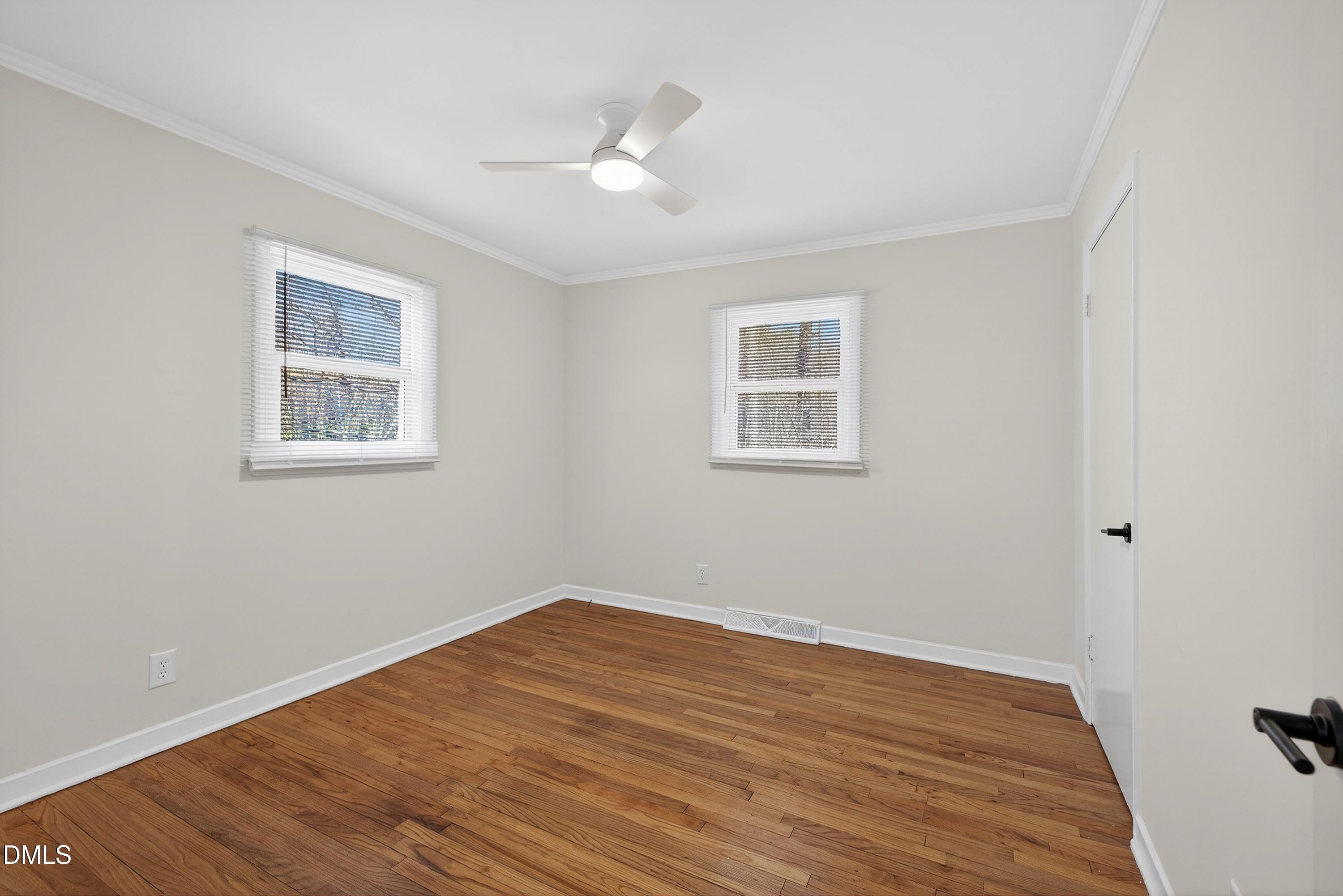 302 Normandy Street Durham, NC 27707 - Photo 22 of 29 a view of empty room with wooden floor and fan