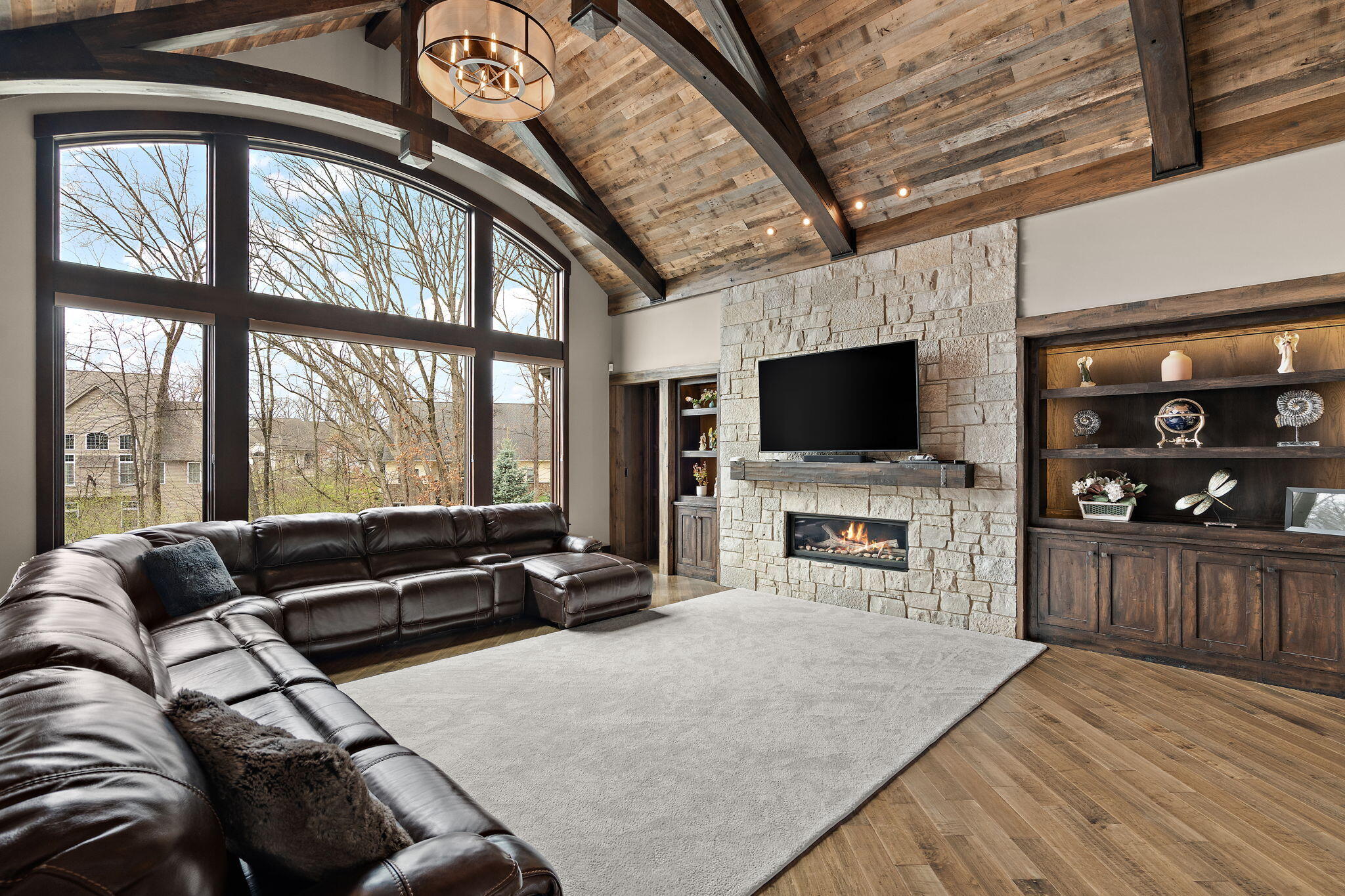 1021 Foy Court Crown Point, IN 46307 - Photo 11 of 88 a living room with furniture a flat screen tv and a fireplace