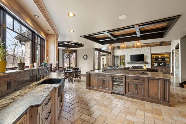 a front view of a house with a garden and trees