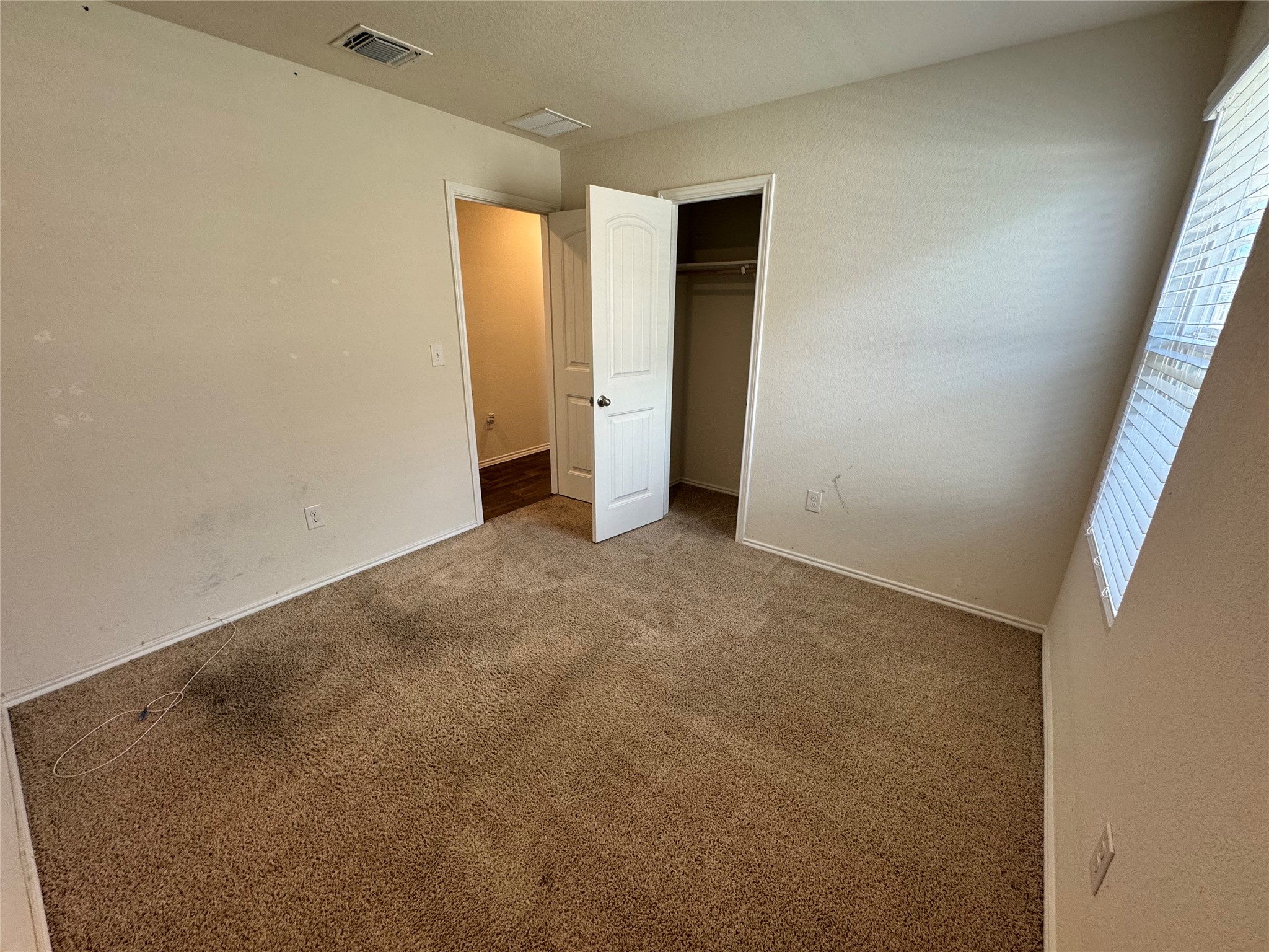 11820 Rush Lane Elgin, TX 78621 - Photo 16 of 31 A comfortable bedroom with soft carpeting awaits new inhabitants.