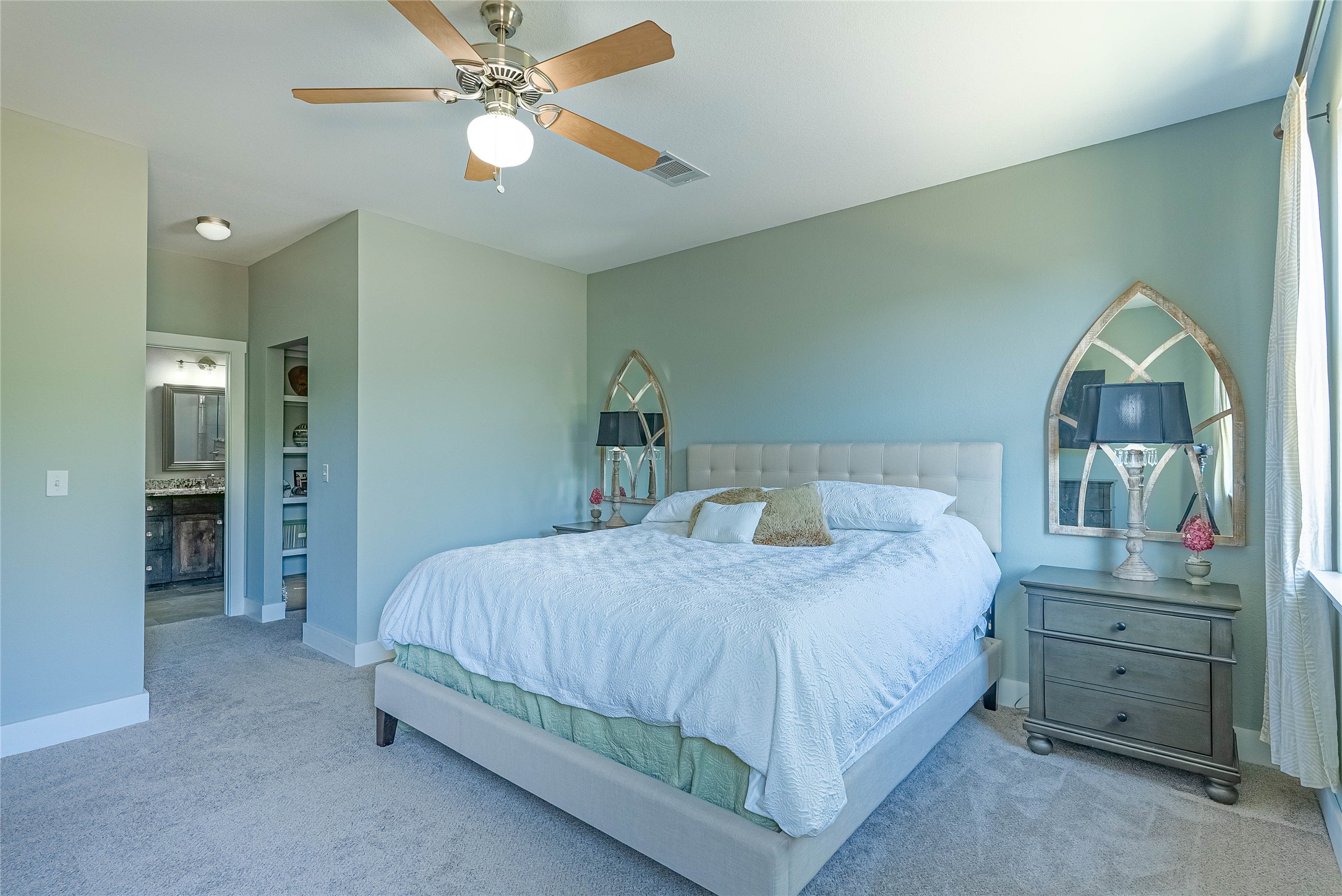 410 Summit Ridge Drive North Point Venture, TX 78645 - Photo 11 of 37 a bedroom with a bed and a chandelier