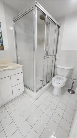 a bathroom with a granite countertop sink mirror and toilet
