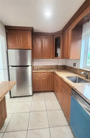 a kitchen with stainless steel appliances granite countertop a stove microwave and sink