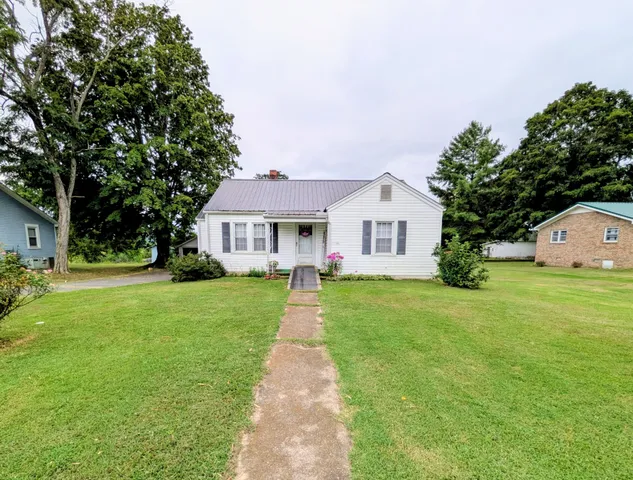 a front view of house with yard and green space