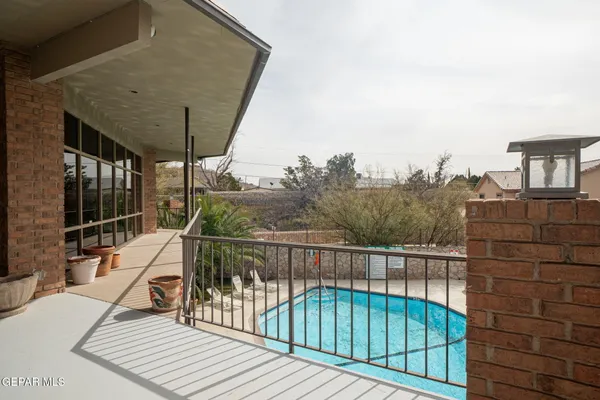 a view of a balcony with two chairs