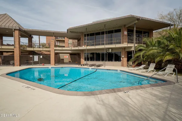 a view of house with a yard and potted plants
