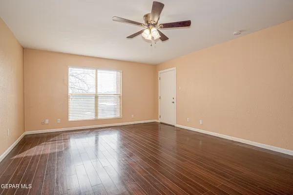 wooden floor in an empty room with a window