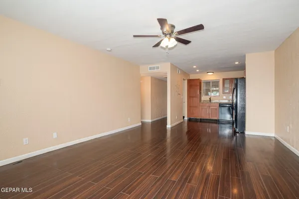 a view of a livingroom with wooden floor and a ceiling fan