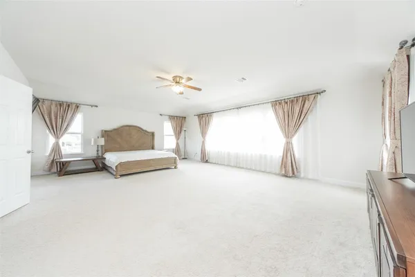 a big room with closet and a chandelier