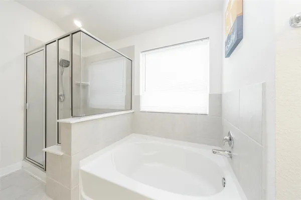 a white bath tub sitting next to a shower