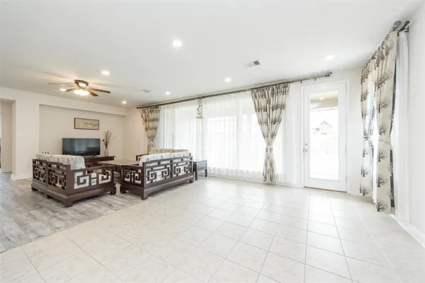 a spacious bedroom with a bed a couch and a window