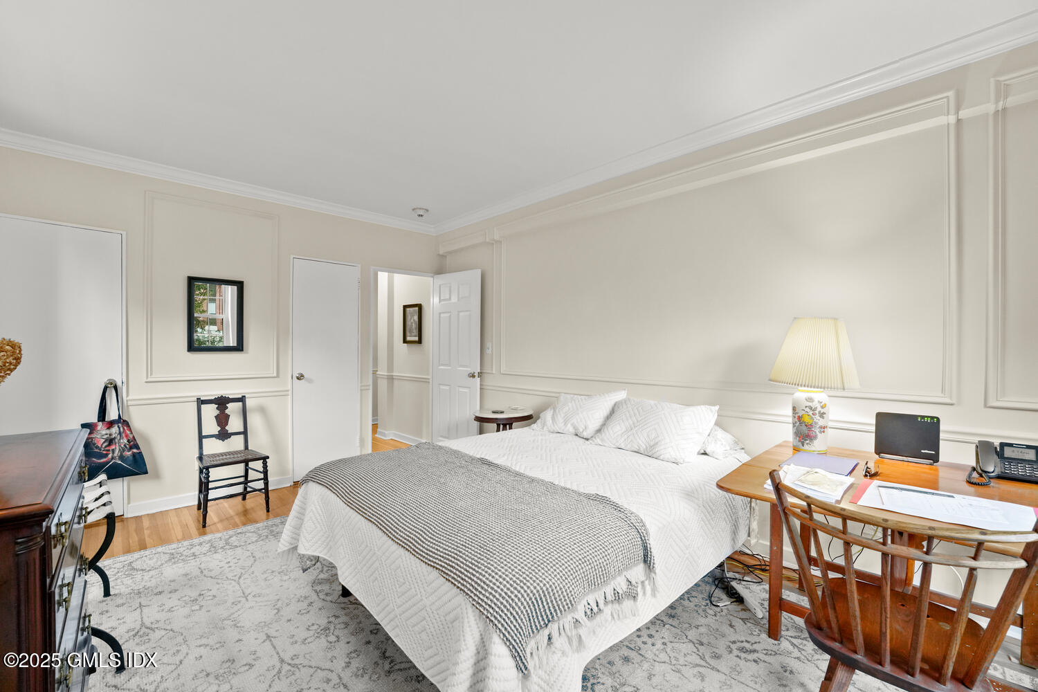 20 Church Street, Unit A34 Greenwich, CT 06830 - Photo 13 of 25 a bedroom with a bed and wooden floor
