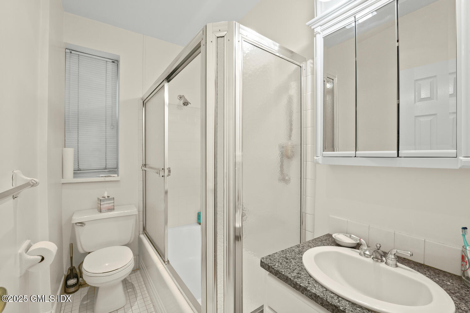 20 Church Street, Unit A34 Greenwich, CT 06830 - Photo 14 of 25 a bathroom with a granite countertop sink toilet and shower