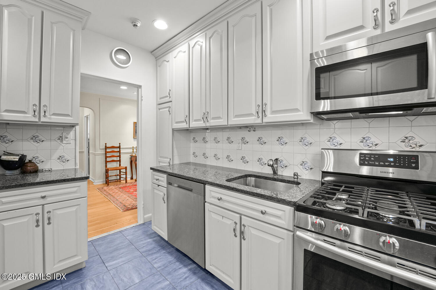 20 Church Street, Unit A34 Greenwich, CT 06830 - Photo 17 of 25 a kitchen with stainless steel appliances granite countertop a stove a sink and a microwave