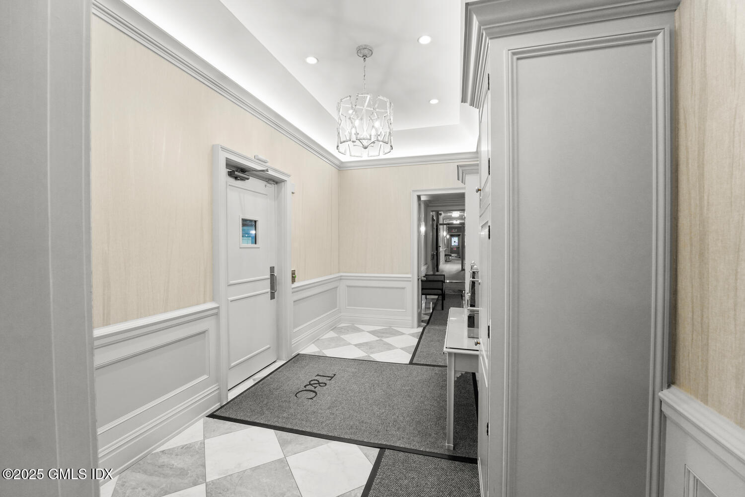 20 Church Street, Unit A34 Greenwich, CT 06830 - Photo 23 of 25 a view of a hallway with wooden floor and chandelier