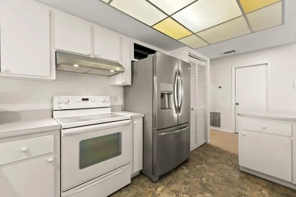 a kitchen with cabinets and stainless steel appliances