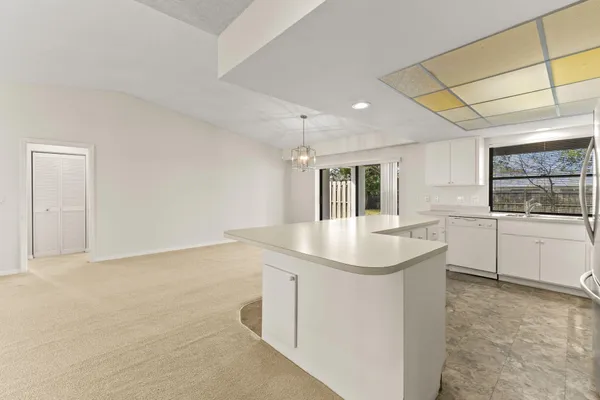 a kitchen with a sink cabinets and window