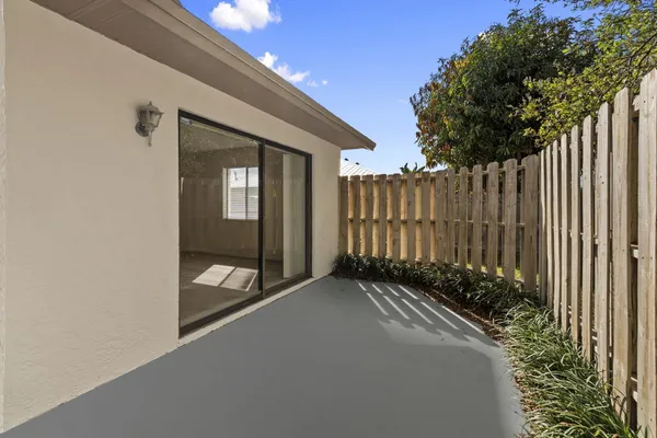 a view of a backyard with wooden fence