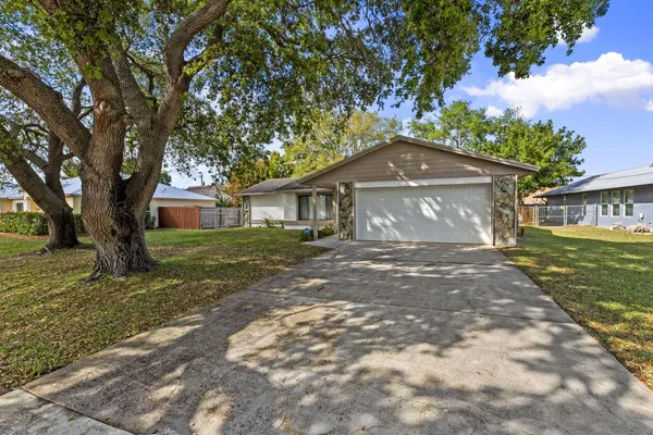 a front view of a house with a yard and a garage