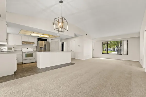 a view of a kitchen with a sink stainless steel appliances and cabinets