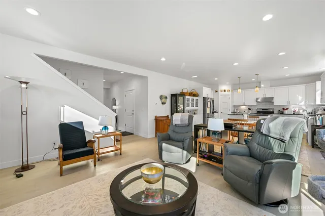 a living room with furniture and kitchen view
