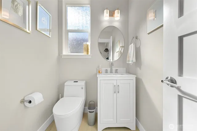a bathroom with a toilet a sink and mirror
