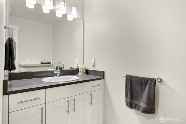 a bathroom with double sink and a mirror