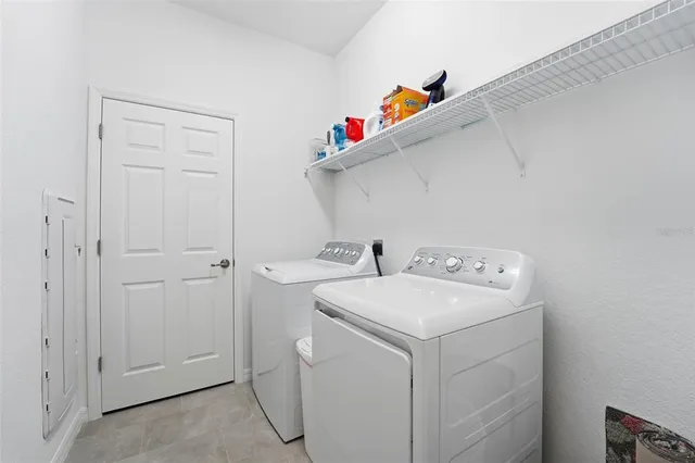 a view of swimming pool with a yard and palm trees