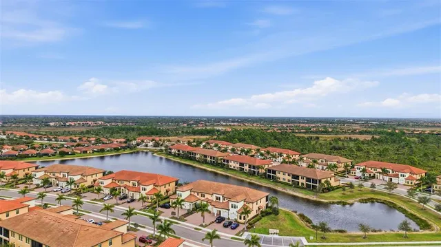 a living room with furniture a flat screen tv and a large window
