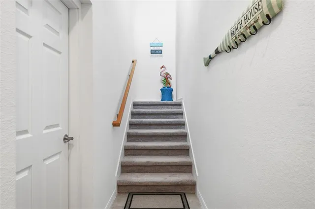 a living room with furniture and a large window with wooden floor