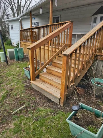 a view of entryway with wooden stairs