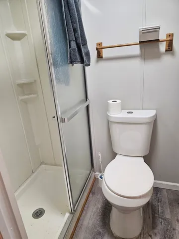 a bathroom with a toilet and a shower