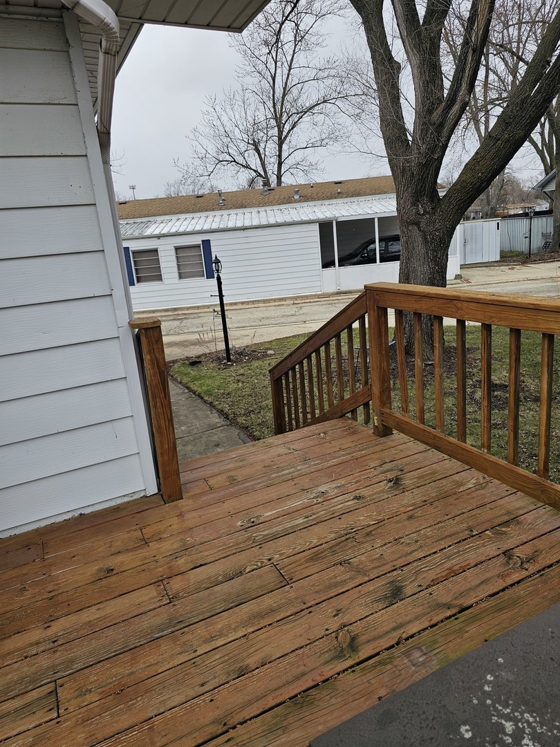 241 Little Peninsula Road Elgin, IL 60123 - Photo 3 of 20 a view of a house with wooden deck and a backyard