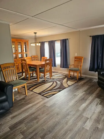 a living room with furniture a window and a flat screen tv