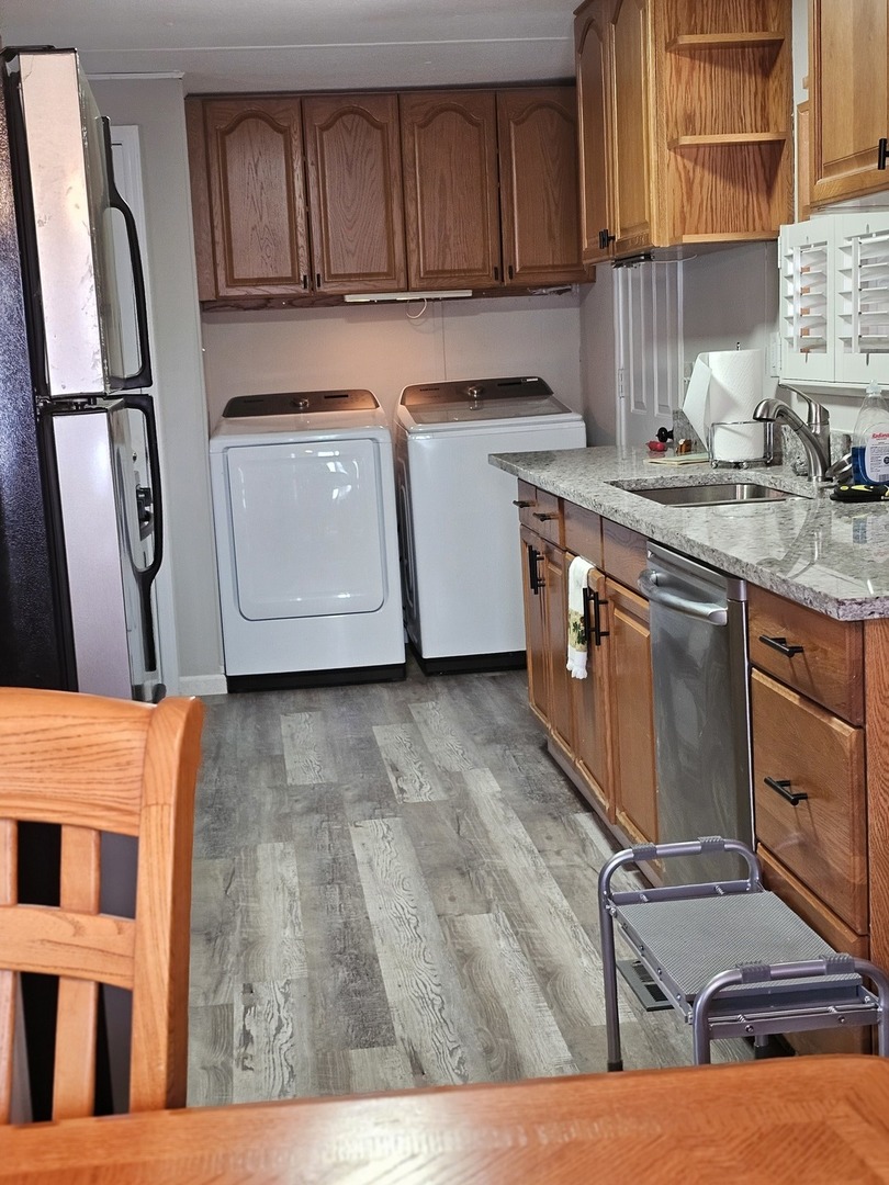241 Little Peninsula Road Elgin, IL 60123 - Photo 5 of 20 a kitchen with stainless steel appliances granite countertop a stove a sink dishwasher and cabinets with wooden floor