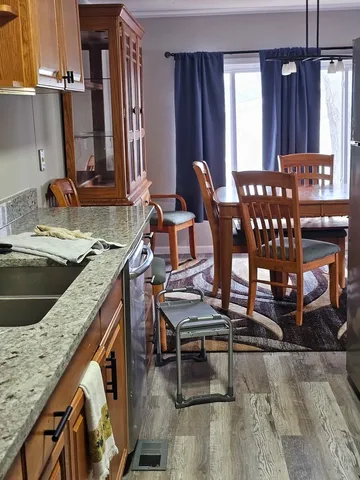 a kitchen with a sink cabinets and dining table