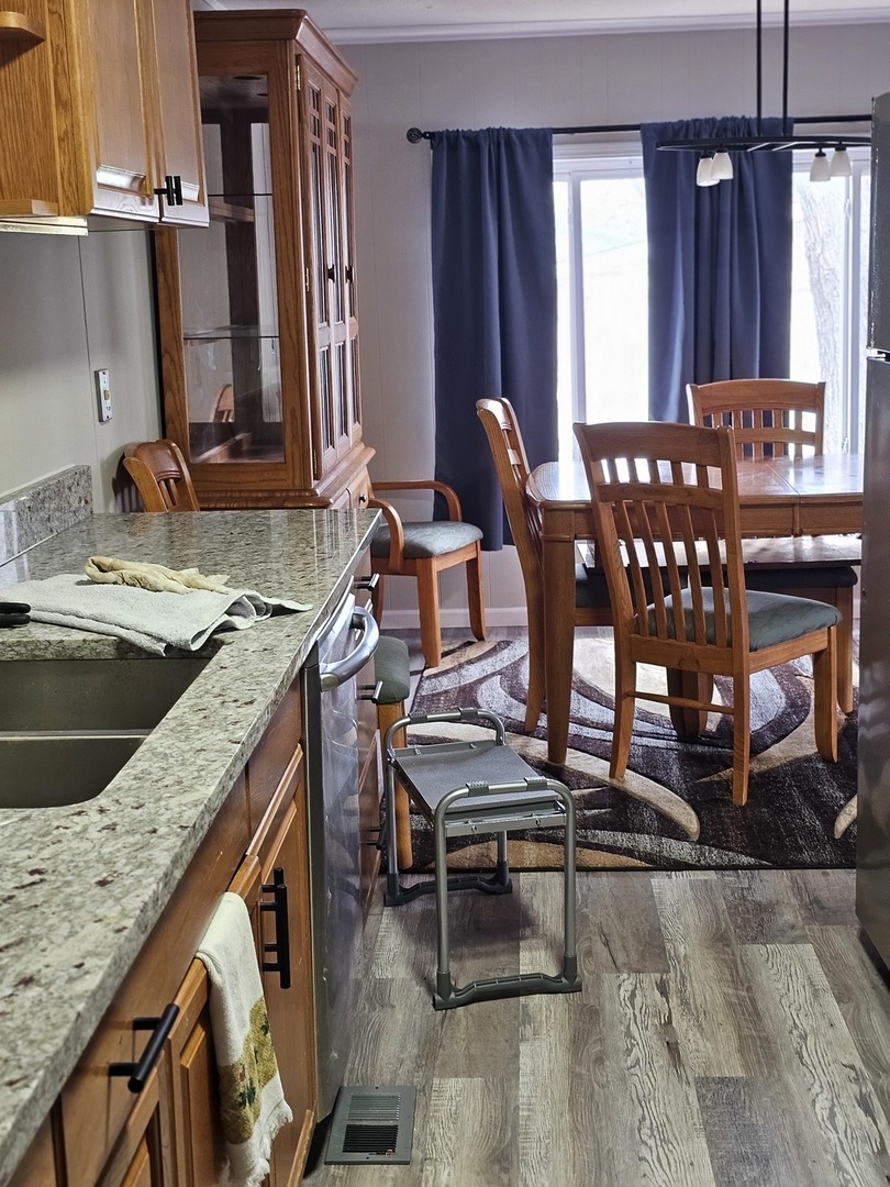 241 Little Peninsula Road Elgin, IL 60123 - Photo 10 of 20 a kitchen with a sink cabinets and dining table