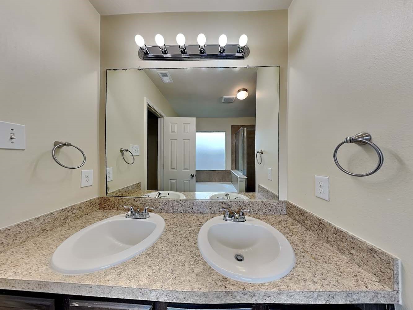 3719 Iris Ridge Way Fresno, TX 77545 - Photo 11 of 16 a bathroom with a granite countertop sink and a mirror