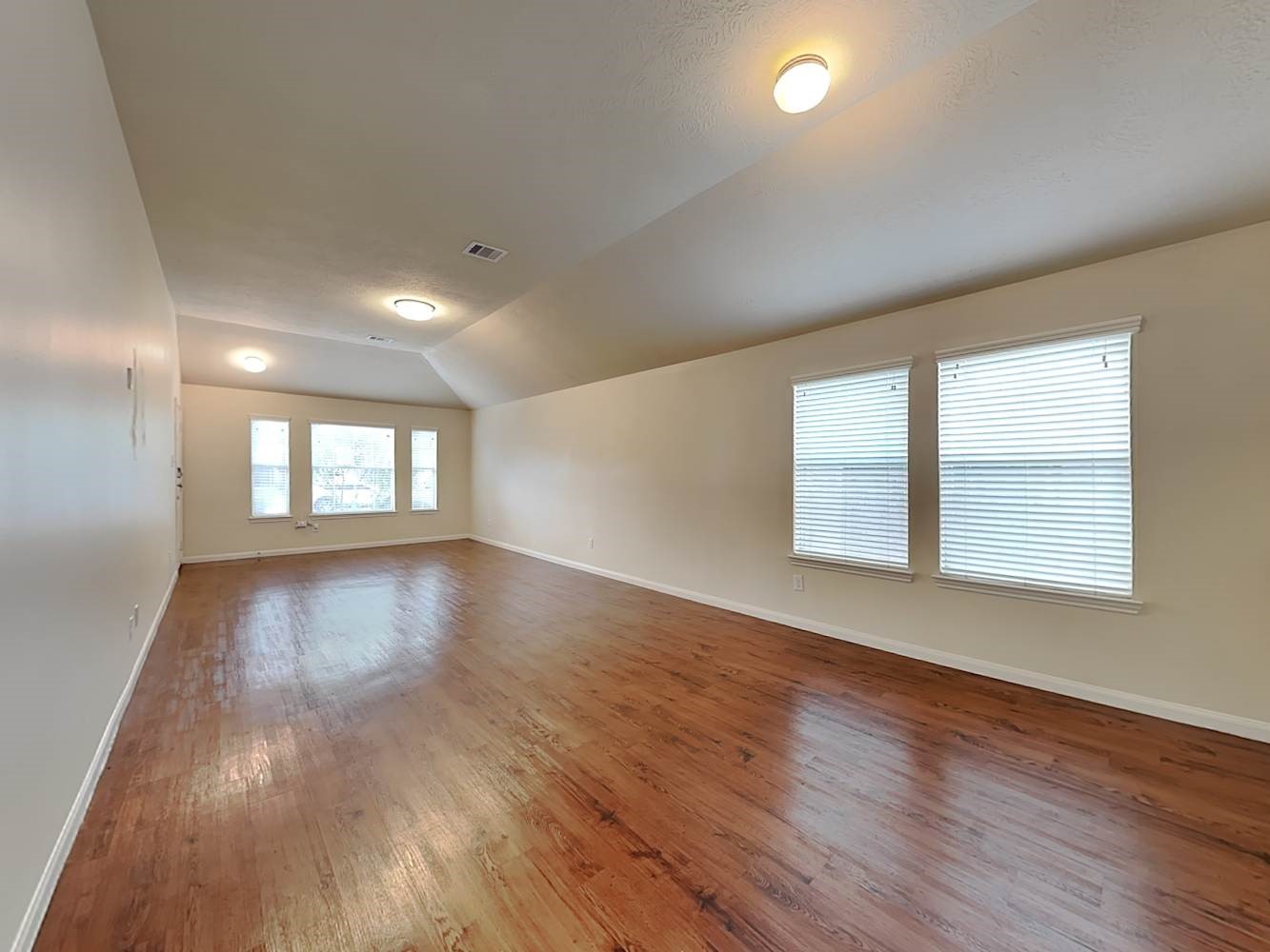 3719 Iris Ridge Way Fresno, TX 77545 - Photo 6 of 16 an empty room with wooden floor and windows