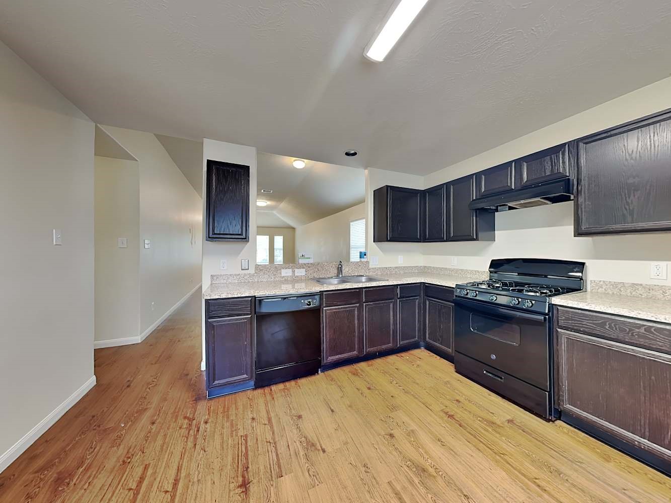 3719 Iris Ridge Way Fresno, TX 77545 - Photo 7 of 16 a kitchen with stainless steel appliances granite countertop a sink stove and refrigerator
