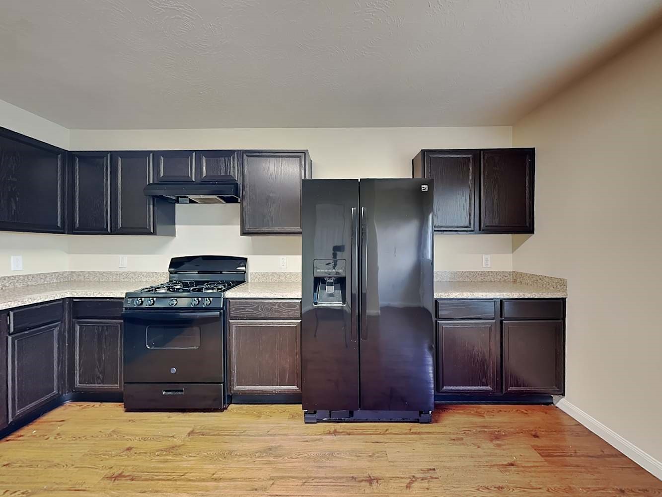 3719 Iris Ridge Way Fresno, TX 77545 - Photo 8 of 16 a kitchen with stainless steel appliances granite countertop a stove a refrigerator and a sink with wooden cabinets